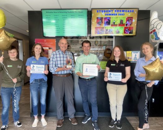 A photo of people holding awards.