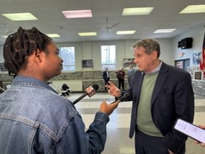 A person interviewing another person.