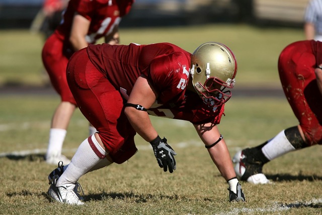 A photo of a football player during a game.