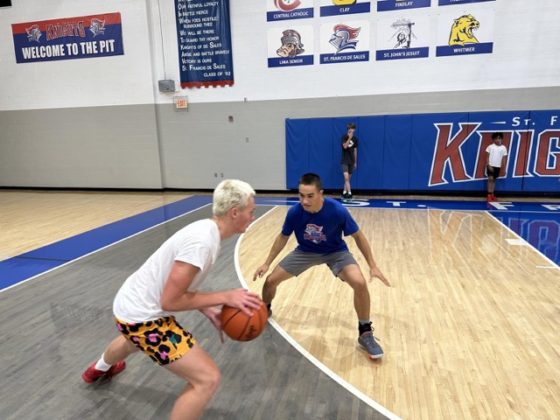 Two kids playing basketball