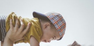 A parent holding a child.