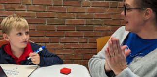 A tutor working with a kid.