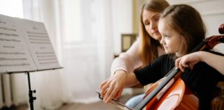 A music teacher working with a student.