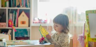 A child playing at a desk.