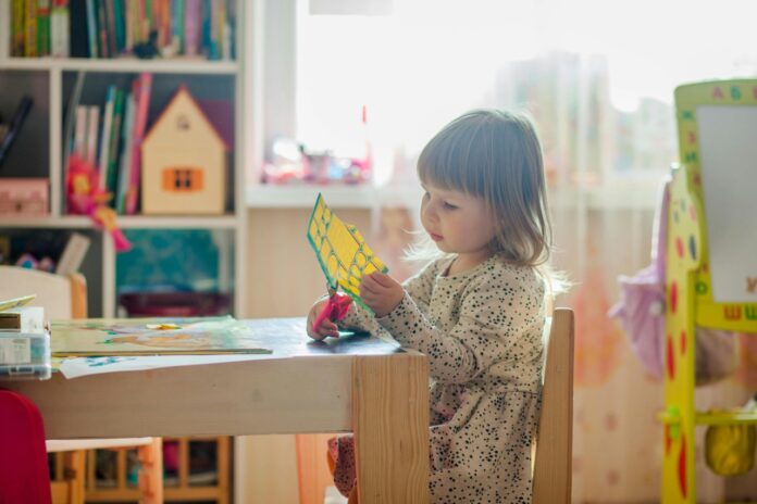 A child playing at a desk.