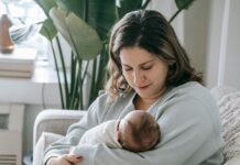 A parent holding their child.