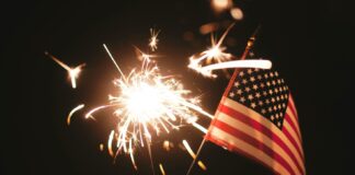 An American flag and a sparkler