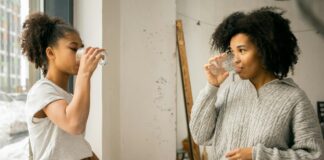 Mother and daughter drinking water