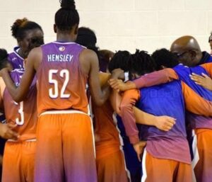 A group of basketball players in a huddle.