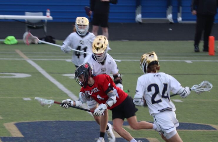 Teens playing lacrosse