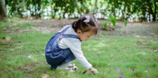 A child playing in the grass.