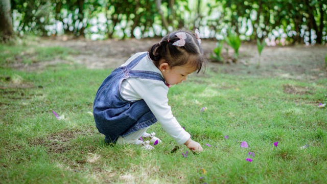 A child playing in the grass.