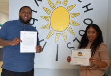 Proudly holding certificates