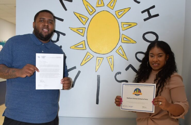 Proudly holding certificates