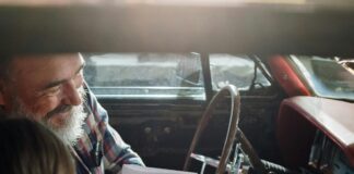 Father and daughter looking at a card