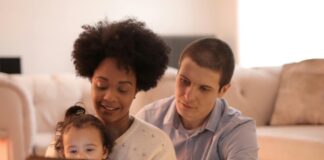 Parents reading with their child.