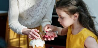 A child helping a parent cook.