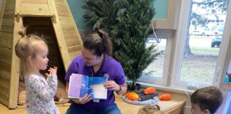 A teacher with a group of kids.