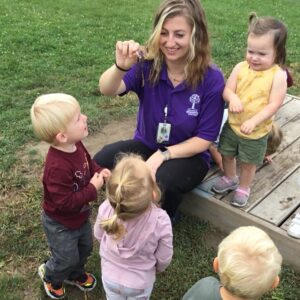 A teacher with a group of kids.