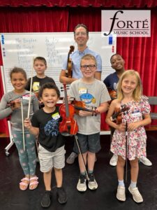 A group of children holding intruments.