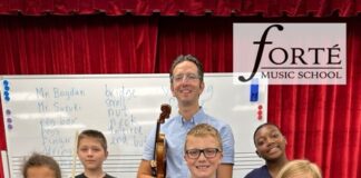 A group of children holding intruments.