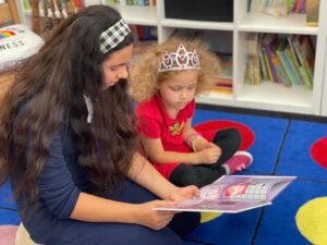 A teacher working with a child.