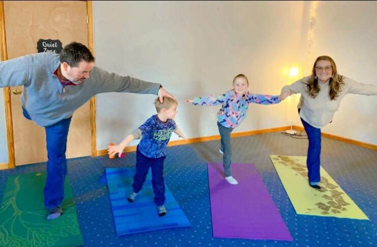 Family doing yoga together at BeLove Parenting class