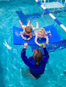 Kids on floaty in swimming pool