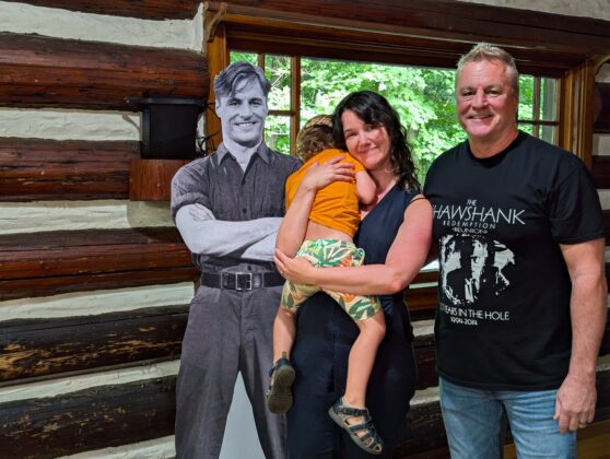 A man, woman, child and cardboard cutout
