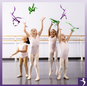 Four young ballet dancers with ribbons