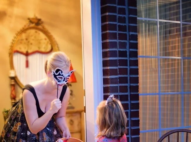 Girl trick or treating wearing princess costume