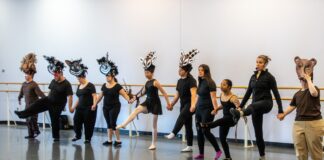 Dancers in line and wearing costumes