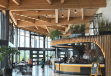Interior of restaurant with wood design and windows