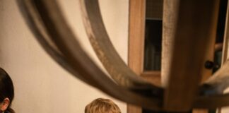 Young boy passing plate at dinner table