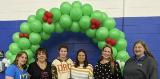 Group of 6 in front of balloon arch