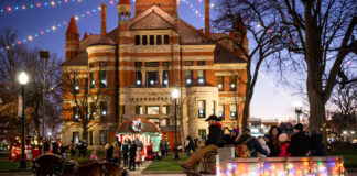 lit building with horse drawn carriage