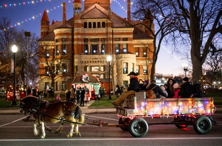 lit building with horse drawn carriage