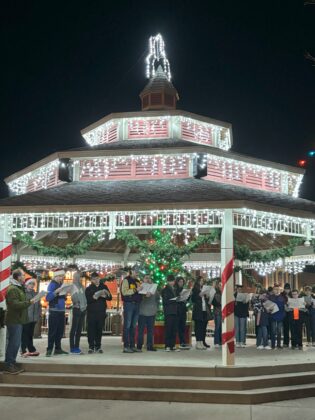 lit pavilion with lrge crowd