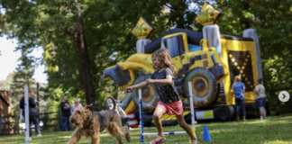 Girl running after dog through course