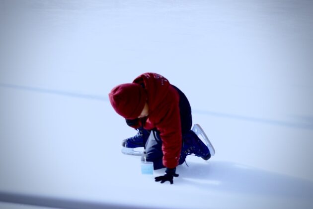 kid kneeling on ice