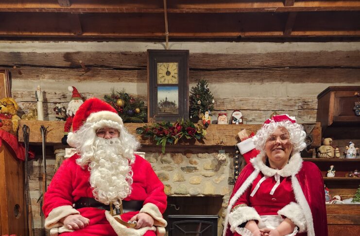 Santa and Mrs. Claus in chairs in cabin