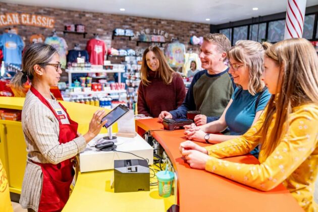 People at counter at colorful candy store