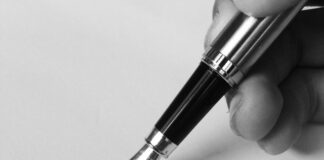 Black and white photo of pen and paper