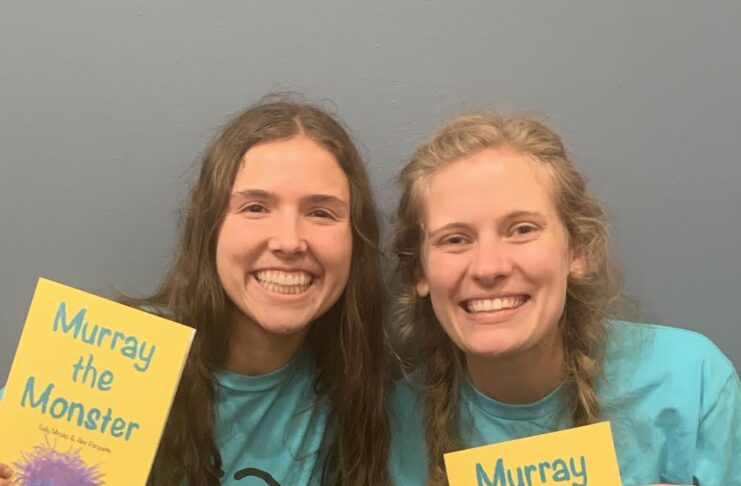 2 women holding books