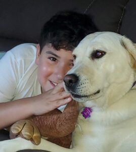 Boy cuddling with dog