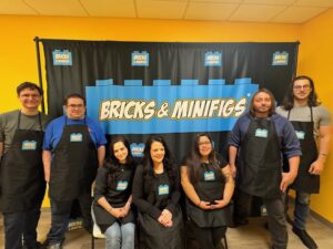Group in front of black and blue banner