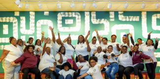 Photo of group holding hands up in excitement