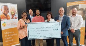 Group holding giant check