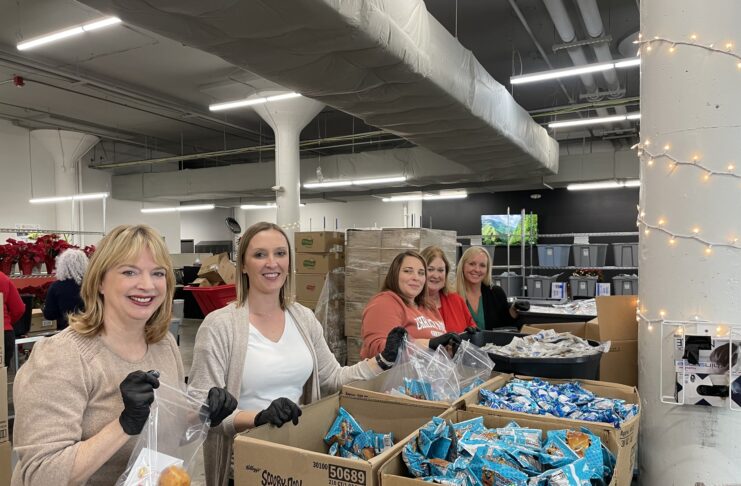 Volunteers by boxes of food