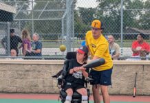A University of Toledo baseball player volunteering with Miracle League of Northwest Ohio.